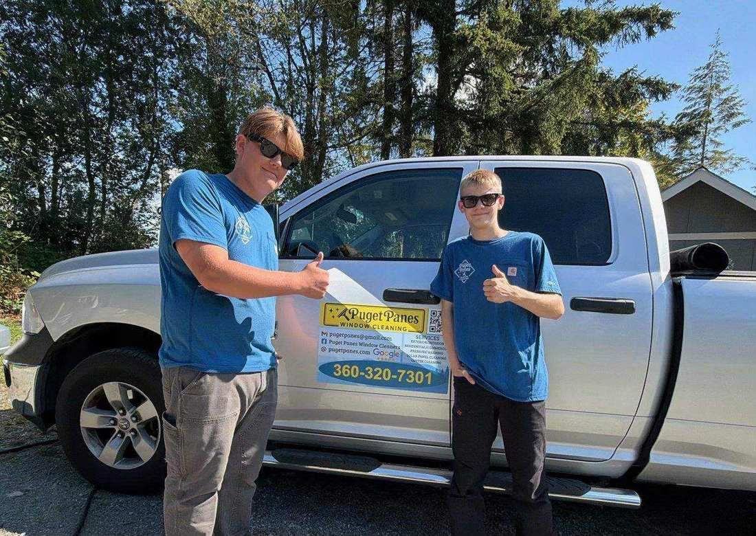 The Puget Panes Window Cleaning crew standing in front of their work truck