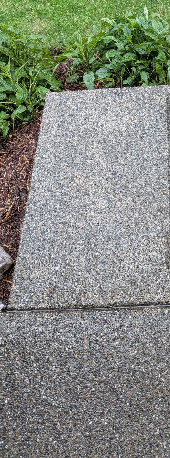 Restored, clean concrete after pressure washing
