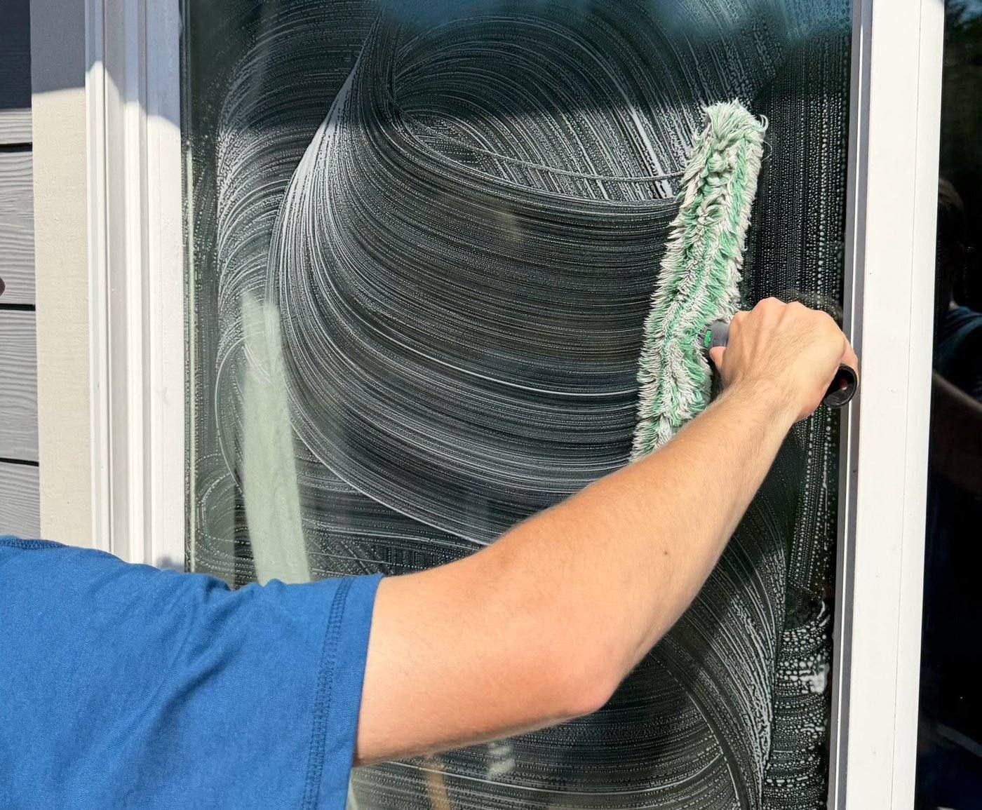 Applying cleaning solution to window glass with a wet towel